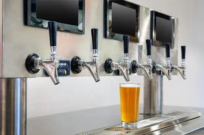 a glass of beer sitting on a counter with two drinking stations at Homewood Suites by Hilton Orlando-UCF Area in Orlando