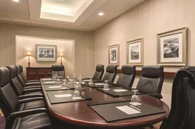 a conference room with a long table and chairs at Embassy Suites by Hilton Orlando International Drive ICON Park in Orlando