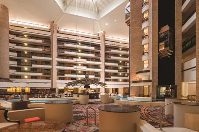 a lobby of a hotel with a large building at Embassy Suites by Hilton Orlando International Drive ICON Park in Orlando