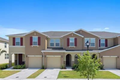 a large house with a garage at Four Bedrooms TownHome 5130 in Kissimmee
