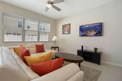 a living room with a white couch and a table at Four Bedrooms TownHome 5130 in Kissimmee