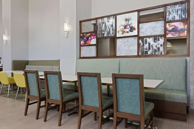 a dining room with a table and chairs at Hampton Inn & Suites Orlando International Drive North in Orlando