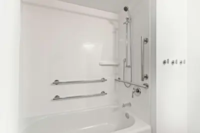 a white bathroom with a shower and a sink at Hampton Inn & Suites Orlando International Drive North in Orlando