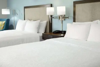 two beds in a hotel room with white pillows at Hampton Inn Orlando Near Universal Blv/International Dr in Orlando