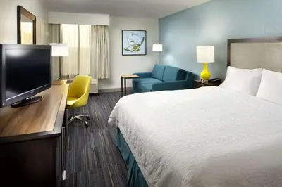 a hotel room with a bed and a flat screen tv at Hampton Inn Orlando Near Universal Blv/International Dr in Orlando