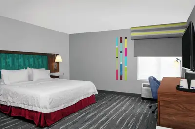 a hotel room with a bed and a flat screen tv at Hampton Inn Lake Buena Vista / Orlando in Orlando
