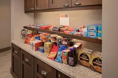 a counter with a bunch of food on it at Homewood Suites by Hilton Orlando Maitland in Orlando