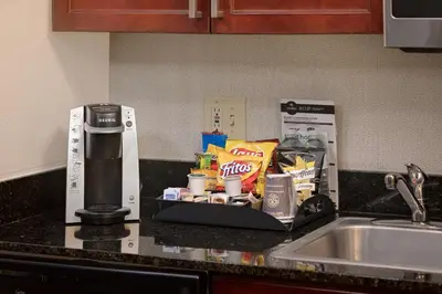 a kitchen counter with a coffeemaker and some food and drinks at Homewood Suites by Hilton Orlando Maitland in Orlando