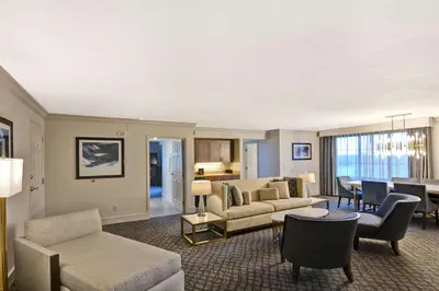 a living room with a couch and chairs and a table at Embassy Suites by Hilton Orlando Downtown in Orlando