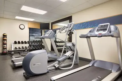 a gym with treadmills and elliptical machines at Hampton Inn Orlando International Drive Convention Center in Orlando