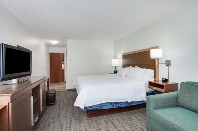 a hotel room with a bed and a flat screen tv at Hampton Inn Orlando International Drive Convention Center in Orlando