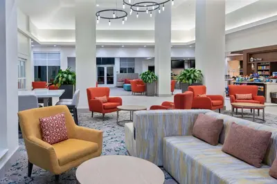 a lobby with couches and tables and chairs at Hilton Garden Inn Orlando International Drive North in Orlando
