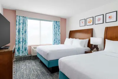 a hotel room with two beds and a window at Hilton Garden Inn Orlando at SeaWorld in Orlando