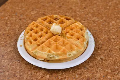 a waffle on a paper plate on a table at Hampton Inn Closest to Universal Orlando in Orlando