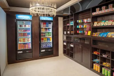 a grocery store aisle with a refrigerator and drinks at Embassy Suites by Hilton Orlando North in Orlando
