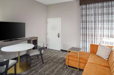 a living room with a couch and a table at Embassy Suites by Hilton Orlando North in Orlando