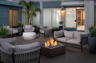 a patio with couches and a fire pit at Hilton Garden Inn Orlando Airport in Orlando