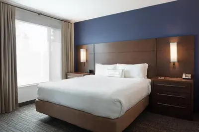 a hotel room with a large bed and a window at Residence Inn by Marriott Orlando at Millenia in Orlando