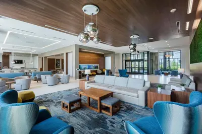 a lobby of a hotel with couches and chairs at Residence Inn by Marriott Orlando at Millenia in Orlando