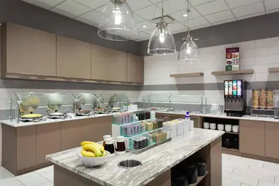 a kitchen with a counter with bananas on it at SpringHill Suites by Marriott Orlando at Millenia in Orlando