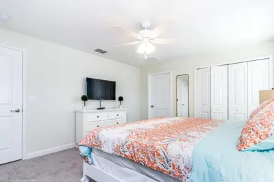 a white bedroom with a bed and a ceiling fan at Romeo Circle #239854 Townhouse in Kissimmee
