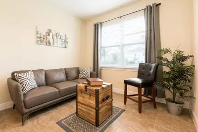 a living room with a couch and a chair at Disney Dreams Luxury Home with Private Water Park in Orlando
