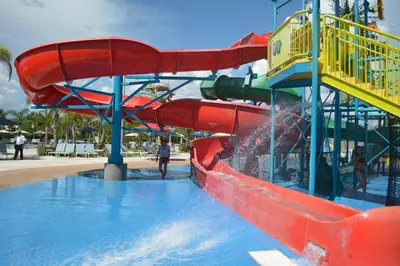 a water slide in a park with people on it at Disney Dreams Luxury Home with Private Water Park in Orlando