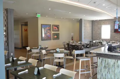 a dining room with tables and chairs in a restaurant at Disney Dreams Luxury Home with Private Water Park in Orlando