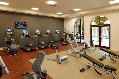 a gym with a bunch of exercise bikes and treadmills at Hilton Grand Vacations Club Tuscany Village Orlando in Orlando