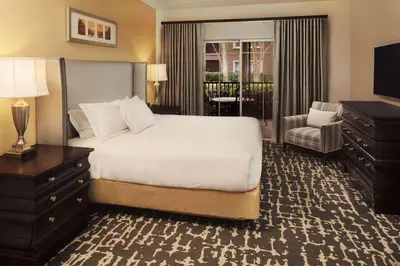 a hotel room with a bed and a television at Hilton Grand Vacations Club Tuscany Village Orlando in Orlando