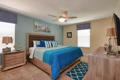 a bedroom with a bed and a ceiling fan at DISNEY area Luxurious House-Private Pool in Kissimmee