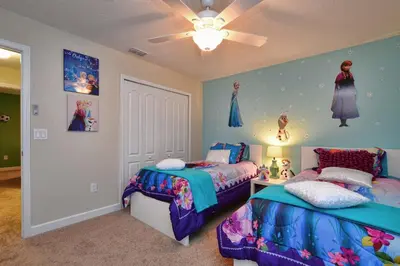 a bedroom with two beds and a ceiling fan at DISNEY area Luxurious House-Private Pool in Kissimmee