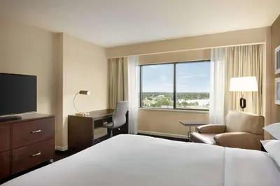 a hotel room with a bed and a desk and a window at DoubleTree by Hilton Orlando Downtown in Orlando