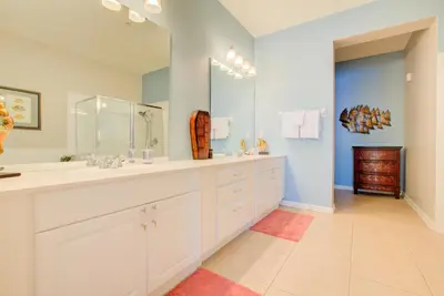 a bathroom with two sinks and a large mirror at Gorgeous 1st-Floor, End Unit Condo w LAKEVIEW in Orlando