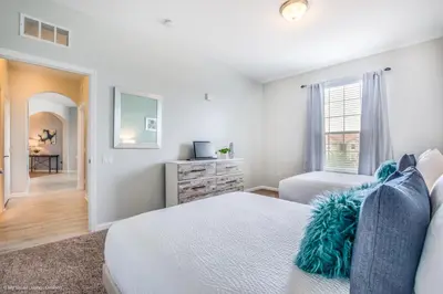 a white bedroom with a bed and a window at Stunning Top-Floor Condo, next to Clubhouse in Orlando