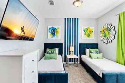 two beds in a room with green curtains at Tropical Treasure in Orlando