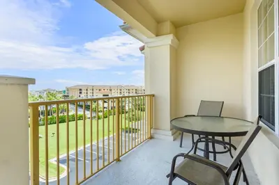 a balcony with a table and chairs on a balcony at Florida Palms in Orlando