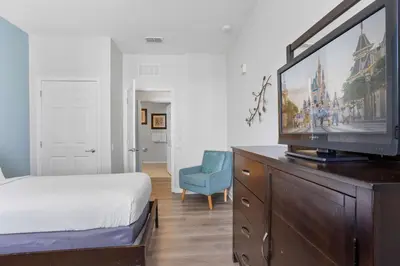 a bedroom with a bed and a television on a dresser at Cozy Condo w FREE Vista Cay Resort Access in Orlando