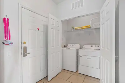 a white laundry room with a washer and dryer at Cozy Condo w FREE Vista Cay Resort Access in Orlando