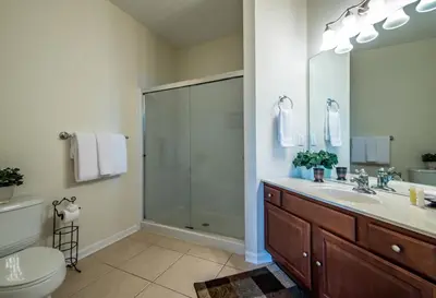 a bathroom with a shower and a sink and a toilet at Luxurious Condo w Modern Design, near Disney in Orlando
