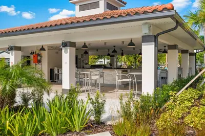 a pavilion with a table and chairs on a patio at Luxurious Condo w Modern Design, near Disney in Orlando