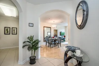 a living room and dining room with a dining table at Luxurious Condo w Modern Design, near Disney in Orlando