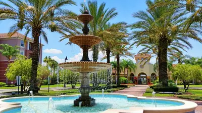 a fountain in a park with palm trees at Luxurious Condo w Modern Design, near Disney in Orlando