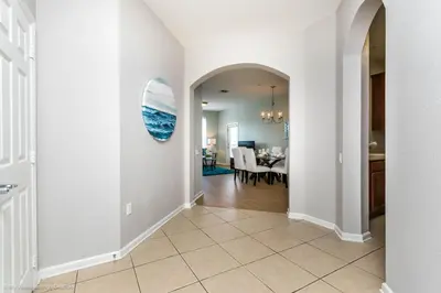 a hallway of a home with a dining room at Spacious Condo Near Convention Ctr & I-Drive, Pool in Orlando