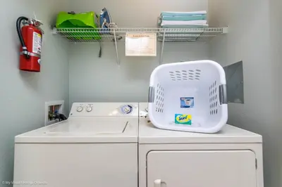 a laundry room with a sink and a washing machine at Spacious Condo Near Convention Ctr & I-Drive, Pool in Orlando