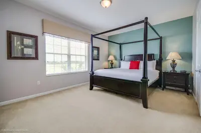 a bedroom with a four poster bed and a window at LAKEVIEW Condo at Vista Cay Resort in Orlando