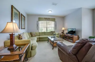a living room with a couch and a tv at LAKEVIEW Condo at Vista Cay Resort in Orlando