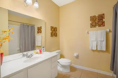 a bathroom with a sink and a toilet at Beautiful Condo at Vista Cay Resort Near WDW in Orlando