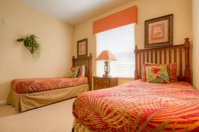 a bedroom with two beds and a window at Palm Villa in Orlando