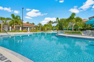 a swimming pool at a resort with palm trees at Majestic Holiday in Orlando